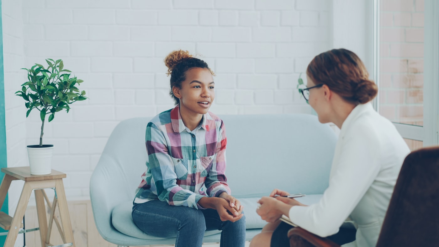 A provider and client talking together in a bright office